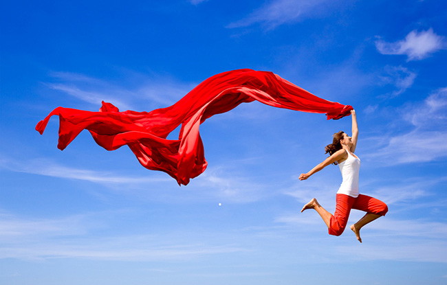 A girl with a red scarf is dancing in the sky